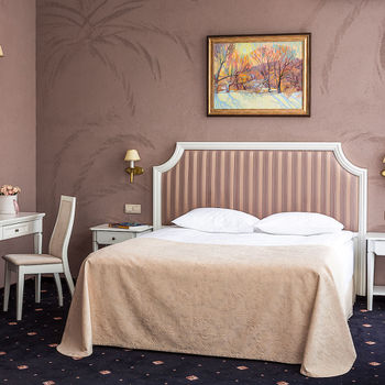 White double bed with high soft back, bedside tables, white dressing table with a mirror, Orion chair &mdash; series of luxury hotel furniture Holly.