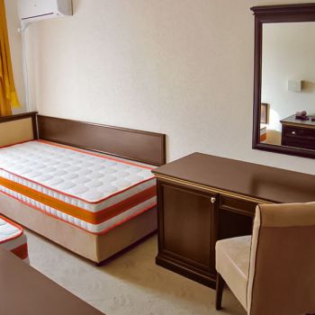 Photo of single bed, dressing table with minibar and mirror of hotel furniture Karolina