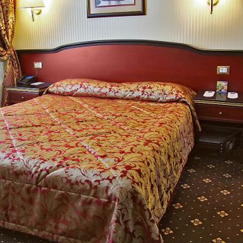 Photo of the bed and bedside tables of hotel furniture  Raffaella