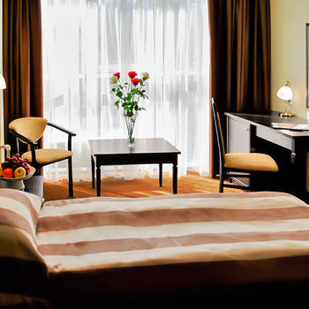 Hotel room &mdash; Black Sea. Double bed, dressing table with mirror, coffee table, chair with soft back Alexis, Orion chair &mdash;  furniture from the Verona series.
