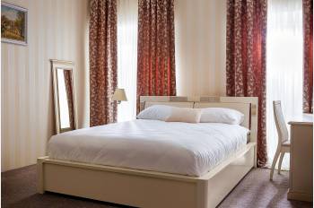 Photo of the Karina bed in tinted ivory with gold